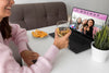 Smiley Woman Celebrating At Home With Friends Over Laptop And Drink Psd