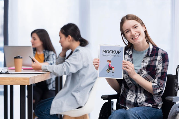 Smiley Woman In Wheelchair At Work With Colleagues Psd