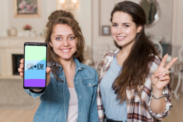 Smiling Girls Presenting Smartphone Mockup Psd