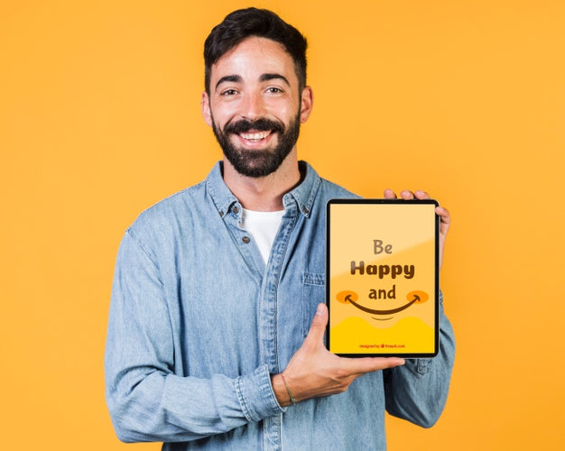 Smiling Young Man Holding Tablet Mock Up Psd