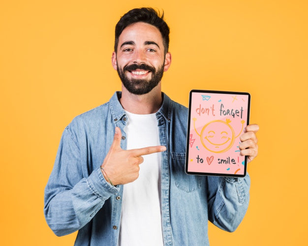 Smiling Young Man Pointing Finger At Tablet Mock Up Psd