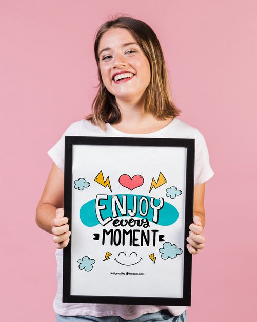 Smiling Young Woman Showing A Frame Mock-Up Psd
