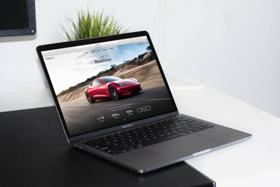 Space Gray Macbook on A Table PSD Mockup