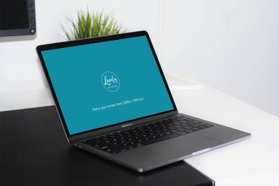 Space Gray Macbook on A Table PSD Mockup