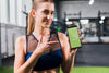 Sporty Woman Pointing At Smartphone Mockup Psd