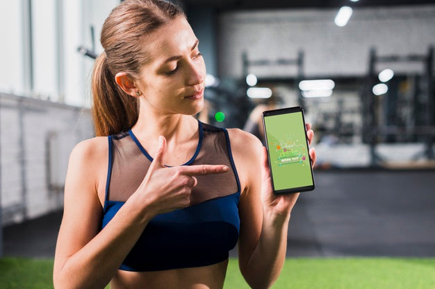Sporty Woman Pointing At Smartphone Mockup Psd