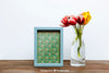 Spring Mockup With Blue Frame And Vase Of Flowers Psd