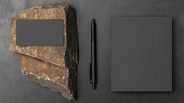 Stationery Mock-Up On Dark Concrete With Rugged Rock Psd