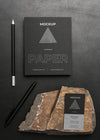 Stationery Mock-Up On Dark Concrete With Rugged Rock Psd