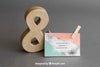 Stationery Mockup With Business Card Leaning Against Ampersand Psd