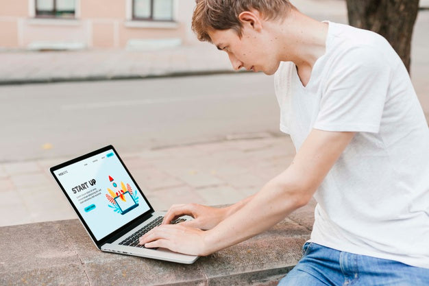 Student Working On Laptop Outdoors Psd