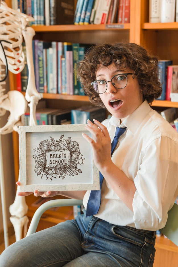 Surprised Woman Holding Frame Mockup In Library Psd