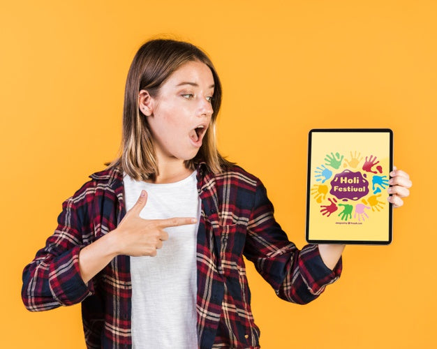 Surprised Young Woman Pointing Finger To A Tablet Mock-Up Psd