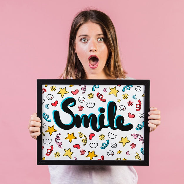 Surprised Young Woman Showing A Frame Mock-Up Psd