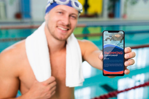 Swimmer In A Pool House Holding A Mock-Up Mobile Phone Psd