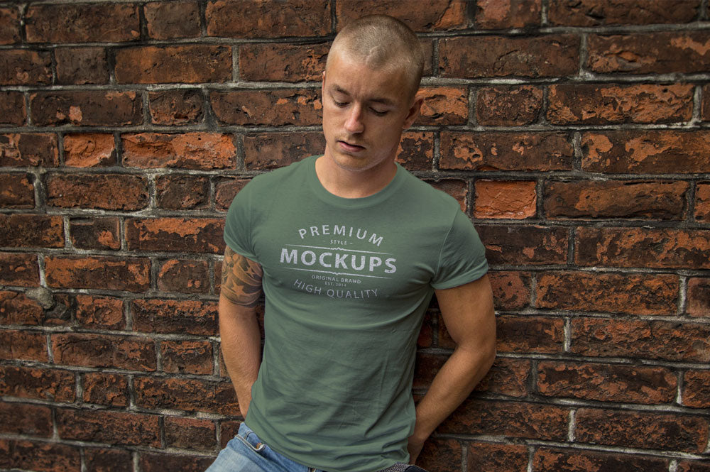 Man Wearing a T-Shirt on a Brick Wall PSD Mockup