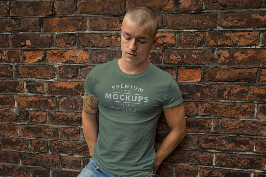 Man Wearing a T-Shirt on a Brick Wall PSD Mockup