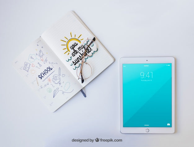 Tablet, Glasses And Notebook With Drawings Psd