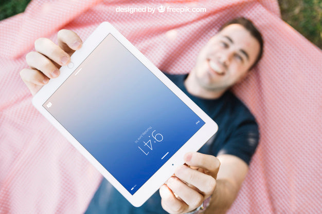 Tablet Mockup With Man Lying On Cloth Psd
