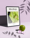 Tablet With Apple And Leaves Shadow Psd