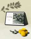 Tablet With Citrus And Leaves Psd