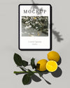Tablet With Citrus Fruit And Leaves Psd