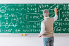 Teacher Writing Math Formulas On Board Psd