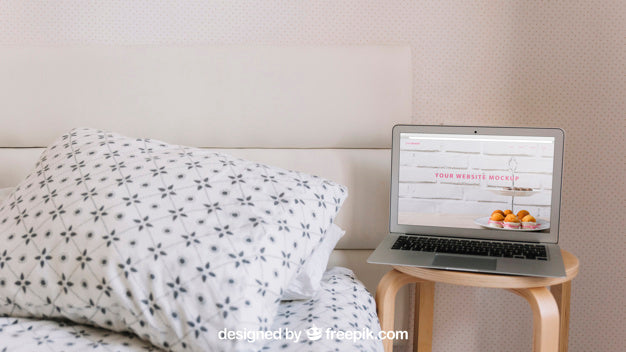 Technology Mockup With Laptop Next To Bed Psd