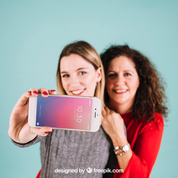 Technology Mockup With Women Presenting Smartphone Psd