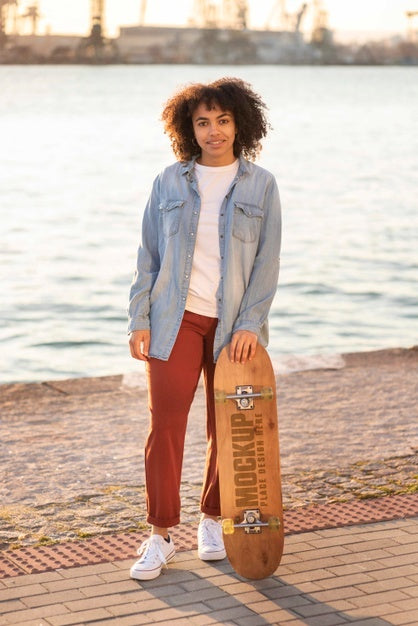 Teenager With Mock-Up Skateboard At The Pier Psd