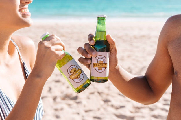 Toasting With Two Beet Bottles At The Beach Psd