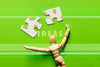 Top View Arrangement With Puzzle Pieces And Wooden Robot Psd