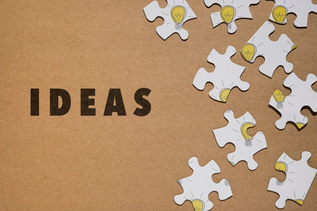 Top View Arrangement With Puzzle Pieces On Brown Background Psd