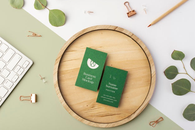 Top View Business Cards On Wood With Leaves Psd
