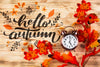 Top View Clock And Leaves On Wooden Background Psd