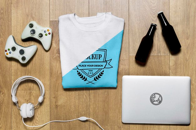 Top View Folded Hoodie Mock-Up With Controllers, Bottles And Headphones Psd