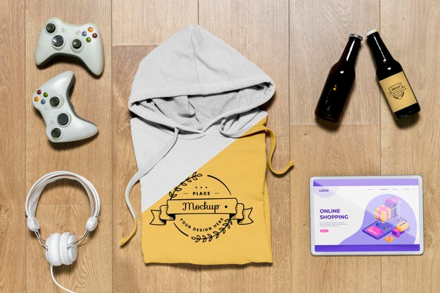 Top View Folded Hoodie Mock-Up With Gadgets And Bottles Psd