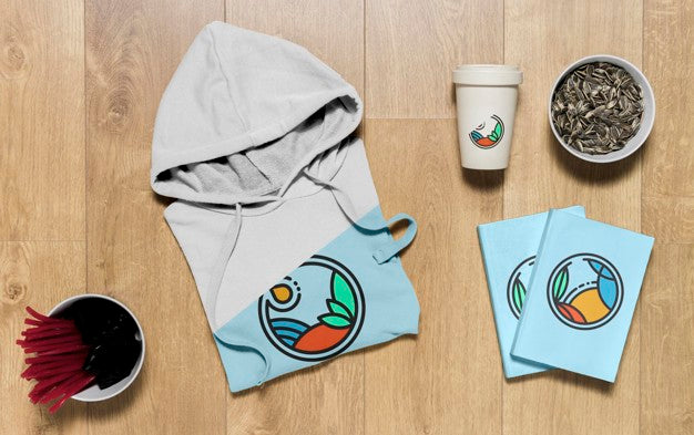 Top View Folded Hoodie Mock-Up With Notebooks  And Sunflower Seeds Psd