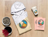 Top View Folded Hoodie Mock-Up With Notebooks, Cup And Sunflower Seeds Psd