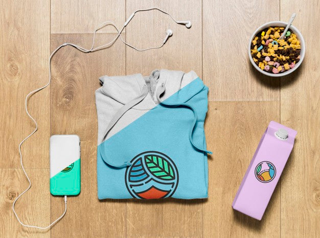 Top View Folded Hoodie Mock-Up With Phone Case, Bottle And Snack Psd