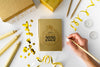 Top View Golden Notepad And Hand Psd