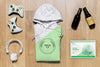 Top View Green Folded Hoodie Mock-Up With Gadgets And Bottles Psd