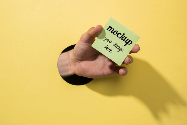 Top View Hand Holding Post-It Psd