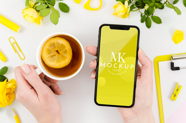 Top View Hands Holding Smartphone Mock-Up With Tea Psd