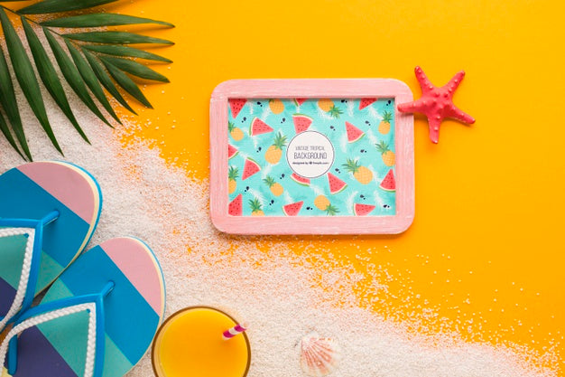 Top View Holiday Frame With Flip Flops And Sand Psd