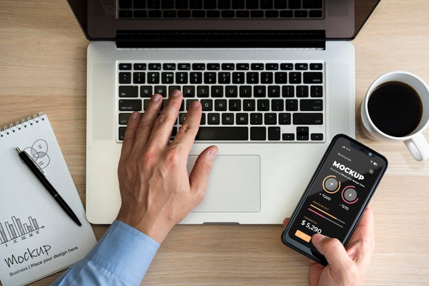 Top View Man Using Laptop And Phone Mock-Up Psd