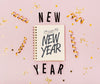 Top View New Year Minimalist Lettering On Notepad Psd