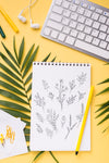 Top View Notebook Mock-Up And Pen Near With Tropical Leaves Psd