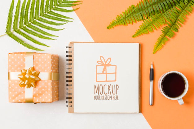 Top View Notebook Mock-Up Next To Birthday Gift Psd