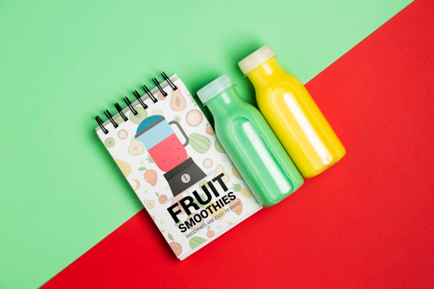 Top View Notepad And Bottles With Fruit Smoothie Psd